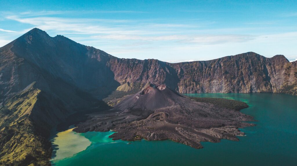 pexels-photo-4870657-4870657 Stunning aerial view of a volcanic island surrounded by blue waters and rugged mountains.